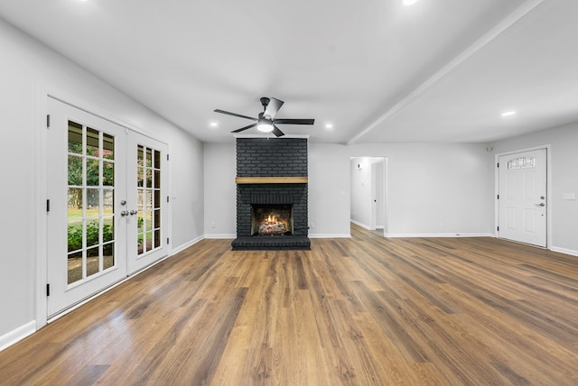 4001 Savannah Dr, Columbus, GA 31907 - unfurnished living room featuring a ceiling fan, french doors, wood finished floors, recessed lighting, and a brick fireplace