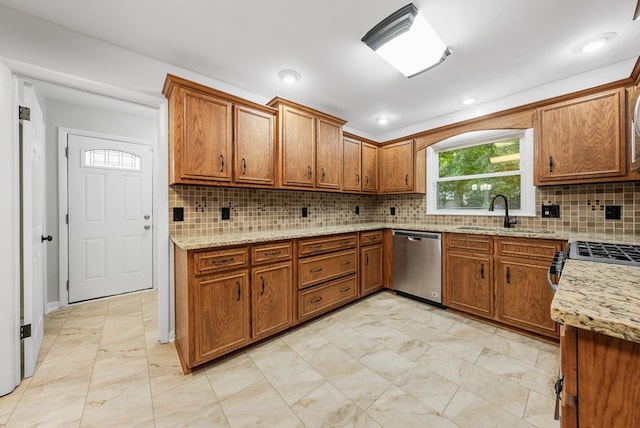 4001 Savannah Dr, Columbus, GA 31907 - kitchen with stainless steel appliances, brown cabinets, light marble finish flooring, light stone counters, and recessed lighting