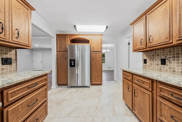4001 Savannah Dr, Columbus, GA 31907 - kitchen with stainless steel fridge with ice dispenser, decorative backsplash, and light stone countertops