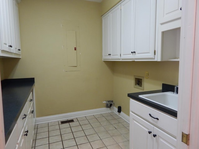 5110 Midland Trce, Columbus, GA 31820 - washroom with washer hookup, cabinet space, baseboards, electric panel, and light tile patterned flooring