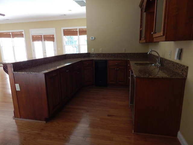 5110 Midland Trce, Columbus, GA 31820 - kitchen featuring a sink, dark stone countertops, wood finished floors, and crown molding