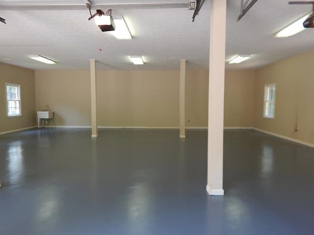 5110 Midland Trce, Columbus, GA 31820 - garage featuring a garage door opener, baseboards, and a sink