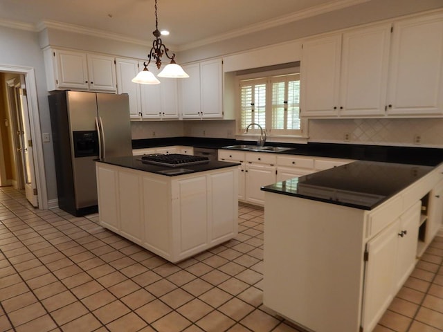 5110 Midland Trce, Columbus, GA 31820 - kitchen featuring stainless steel appliances, dark countertops, a sink, white cabinetry, and ornamental molding