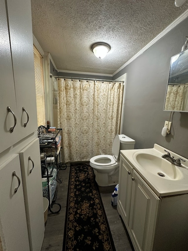 bathroom with toilet, crown molding, a textured ceiling, vanity, and hardwood / wood-style floors