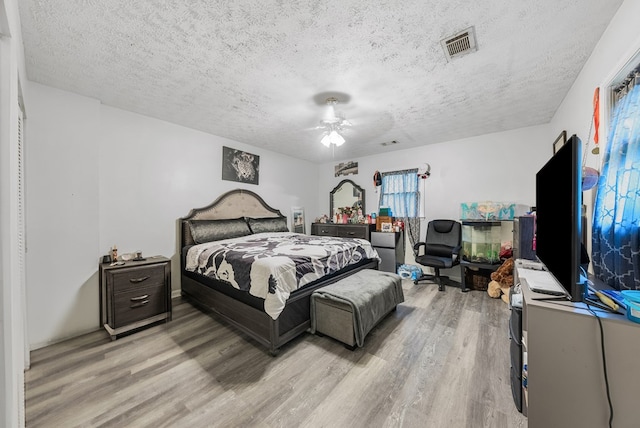5407 Maltese Dr, Columbus, GA 31904 - bedroom with light wood finished floors, a textured ceiling, and a ceiling fan
