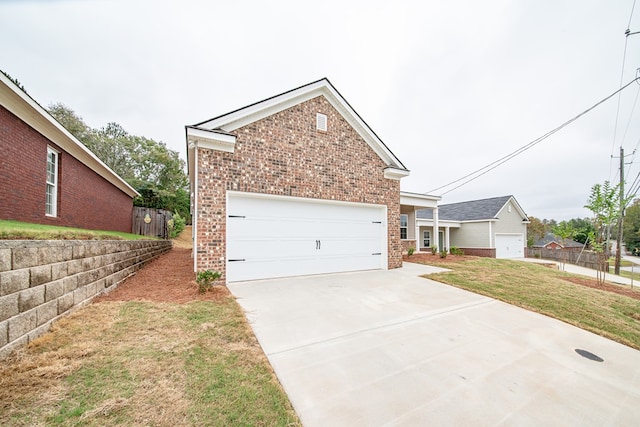 view of front of house with a garage and a front lawn