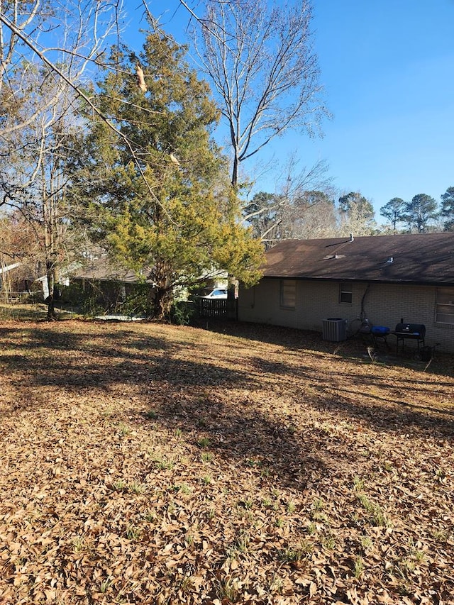 view of yard with fence and cooling unit