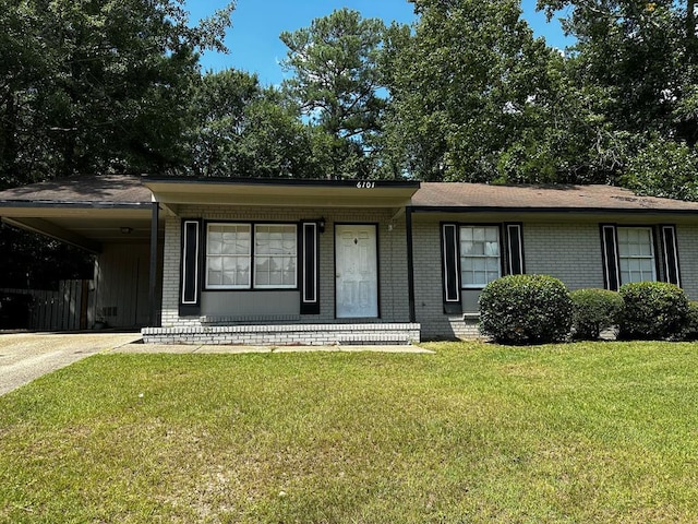 single story home featuring an attached carport, a porch, brick siding, driveway, and a front yard