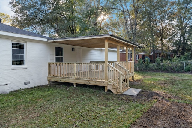 rear view of property with a lawn and a deck