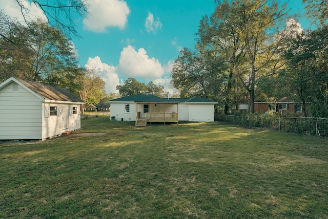 view of yard featuring a storage shed and a deck