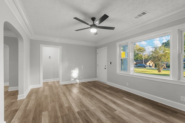 spare room featuring a textured ceiling, light wood-type flooring, and ceiling fan