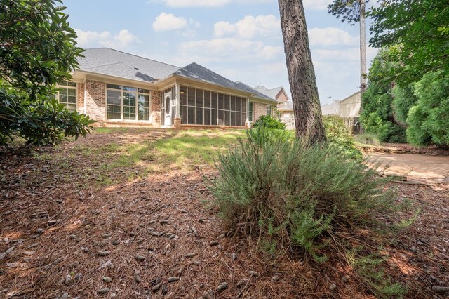 7036 Imperial Way, Columbus, GA 31904 - rear view of property featuring brick siding, a sunroom, and roof with shingles