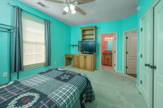 7036 Imperial Way, Columbus, GA 31904 - bedroom with light colored carpet, ceiling fan, and connected bathroom