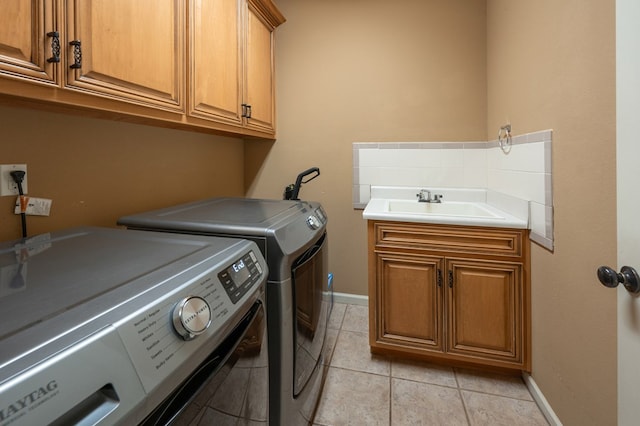 7036 Imperial Way, Columbus, GA 31904 - washroom featuring cabinet space, washing machine and dryer, and light tile patterned floors