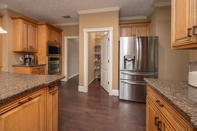 7036 Imperial Way, Columbus, GA 31904 - kitchen featuring appliances with stainless steel finishes, dark wood finished floors, dark stone counters, and crown molding