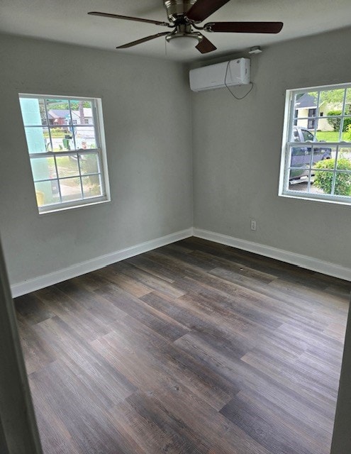 spare room with ceiling fan, dark wood-type flooring, and a wall mounted AC