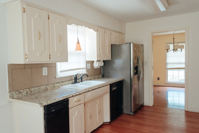 4814 20th Ave, Columbus, GA 31904 - kitchen featuring black dishwasher, healthy amount of natural light, wood finished floors, and light countertops