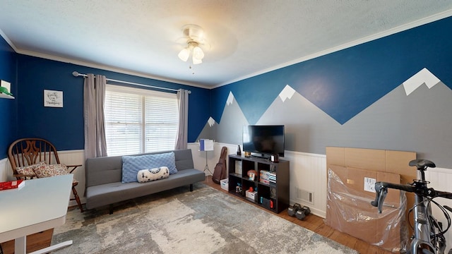 4042 Lyn Dr, Columbus, GA 31909 - living area with wainscoting, wood finished floors, a ceiling fan, ornamental molding, and a textured ceiling