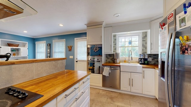 4042 Lyn Dr, Columbus, GA 31909 - kitchen featuring butcher block countertops, stainless steel appliances, decorative backsplash, crown molding, and recessed lighting