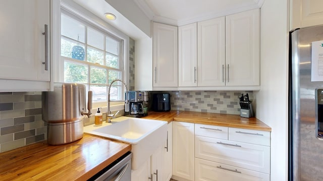 4042 Lyn Dr, Columbus, GA 31909 - kitchen featuring wood counters, freestanding refrigerator, white cabinets, and tasteful backsplash