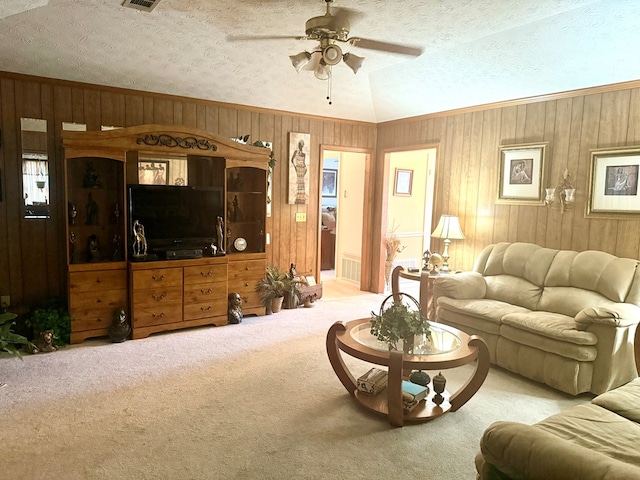 300 Jefferson Dr, Columbus, GA 31907 - carpeted living area featuring a ceiling fan, wood walls, and a textured ceiling