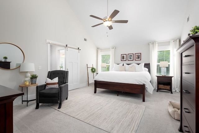 bedroom with a barn door, light colored carpet, high vaulted ceiling, a ceiling fan, and baseboards