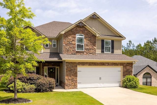 craftsman house with stone siding, an attached garage, and a front yard