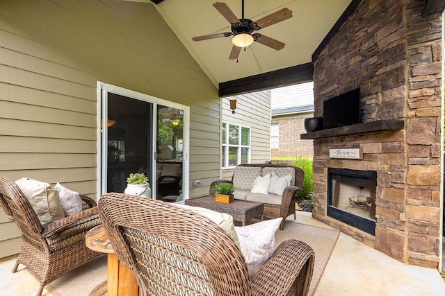 view of patio with ceiling fan and an outdoor living space with a fireplace