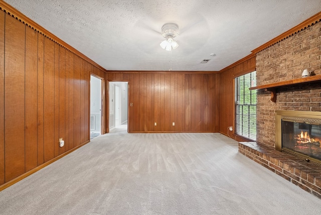 1818 Springvalley Dr, Columbus, GA 31904 - unfurnished living room with a ceiling fan, wood walls, carpet, a fireplace, and crown molding