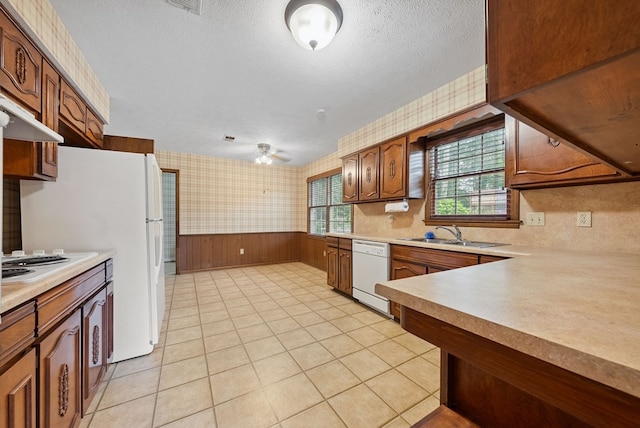 1818 Springvalley Dr, Columbus, GA 31904 - kitchen featuring white appliances, wallpapered walls, light countertops, a wainscoted wall, and a textured ceiling