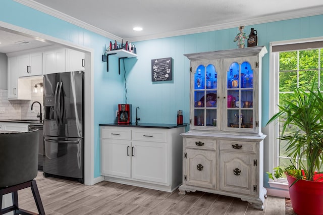 3264 Columbus Hwy, Box Springs, GA 31801 - kitchen featuring refrigerator with ice dispenser, crown molding, a sink, tasteful backsplash, and white cabinetry