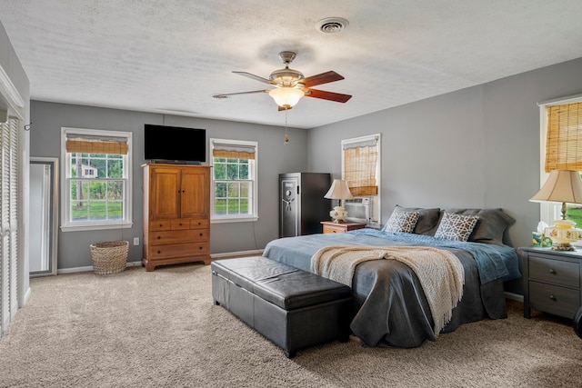 3264 Columbus Hwy, Box Springs, GA 31801 - bedroom with carpet flooring, baseboards, a ceiling fan, and a textured ceiling