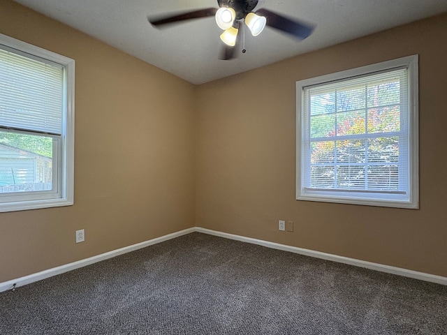 spare room featuring carpet, ceiling fan, and baseboards