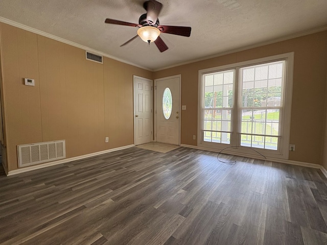 entrance foyer featuring a ceiling fan, dark wood-style floors, ornamental molding, a textured ceiling, and baseboards