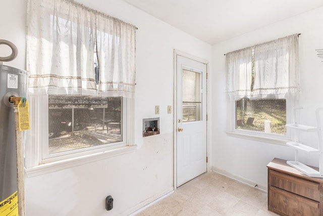 entryway with baseboards and water heater