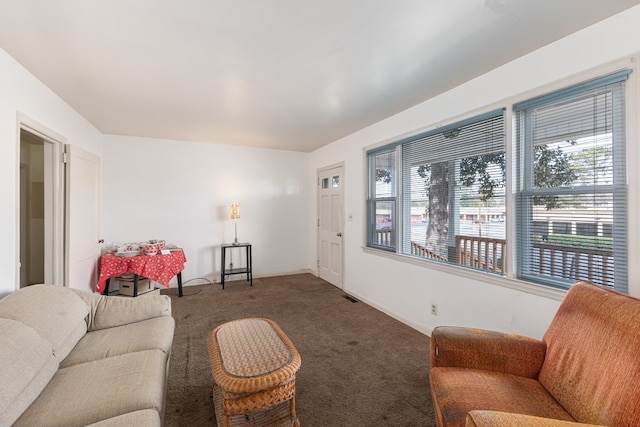 living area featuring visible vents, baseboards, and carpet flooring