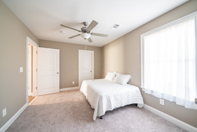 bedroom with ceiling fan and light carpet