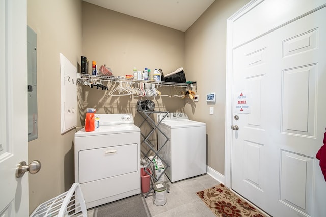 laundry room featuring separate washer and dryer, electric panel, and light tile patterned flooring