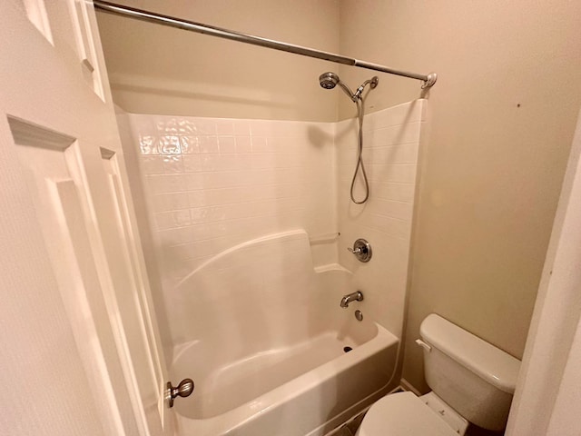 bathroom featuring shower / tub combination and toilet