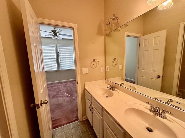 bathroom with tile patterned flooring, vanity, and ceiling fan