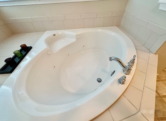 bathroom with a bathing tub and tile patterned flooring