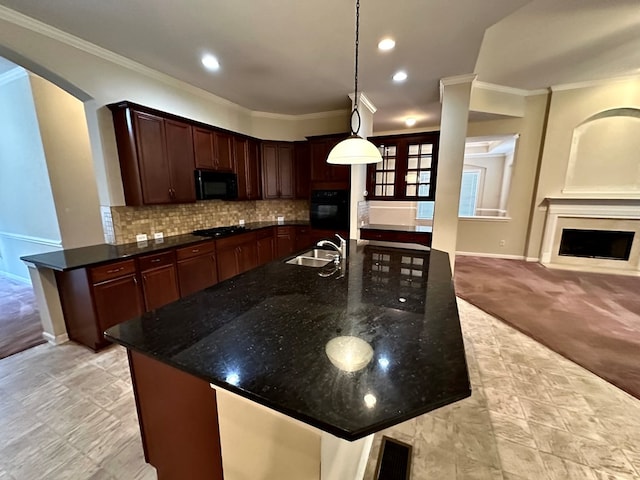 kitchen with light carpet, dark stone counters, crown molding, black appliances, and decorative light fixtures