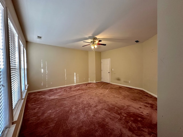 carpeted empty room featuring ceiling fan