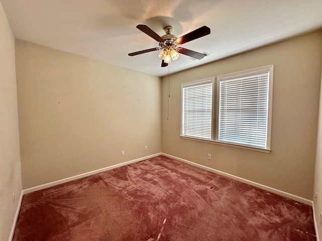 spare room featuring carpet flooring and ceiling fan