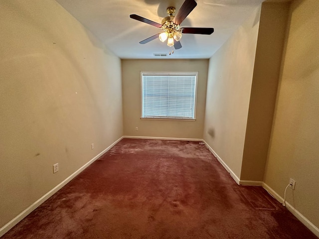 unfurnished room featuring ceiling fan and dark colored carpet