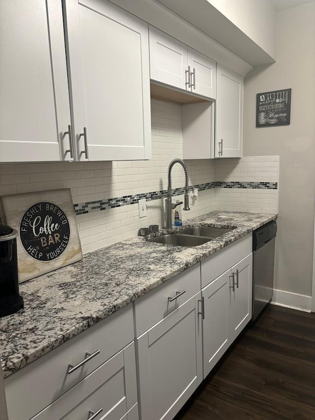 kitchen with dishwasher, dark hardwood / wood-style flooring, white cabinetry, and sink