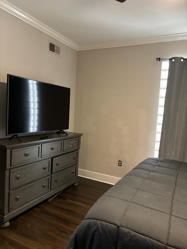 bedroom with crown molding and dark hardwood / wood-style floors