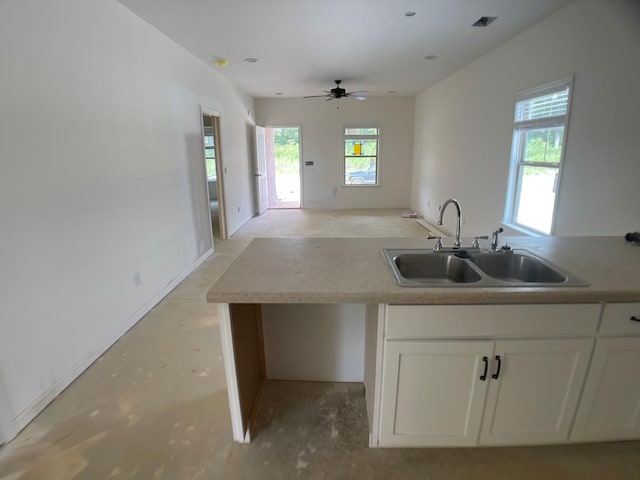 2459 Brownie Ln, Columbus, GA 31903 - kitchen with white cabinets, ceiling fan, open floor plan, and light countertops