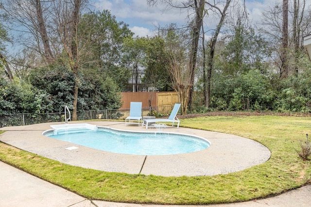 view of swimming pool featuring a patio area, a lawn, a fenced in pool, and fence