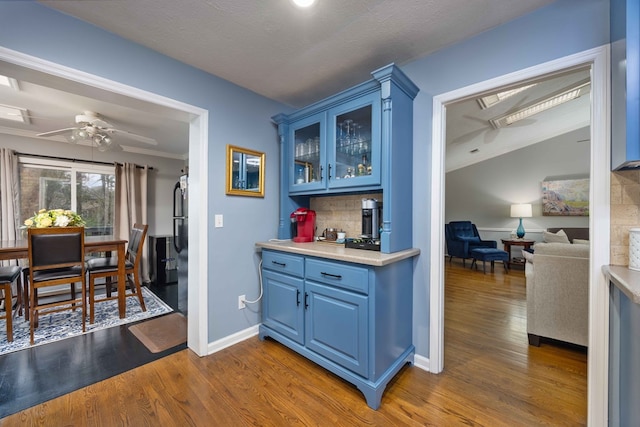 corridor featuring dark wood-type flooring, baseboards, and ornamental molding